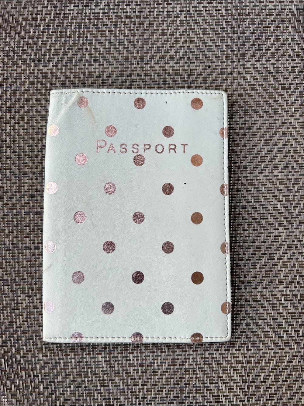 J. Crew cream colored passport case featuring rose gold dot accents.